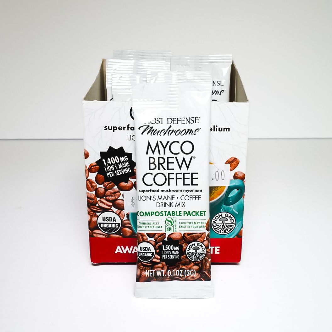 Myco Brew Coffee compostable packet standing in open retail box, black and red packaging with coffee beans