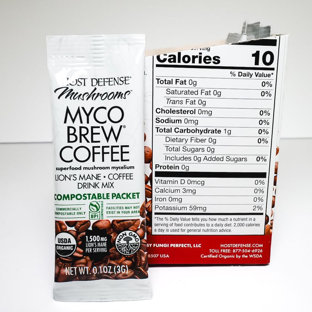 Myco Brew Coffee compostable packet standing in open retail box, black and red packaging with coffee beans