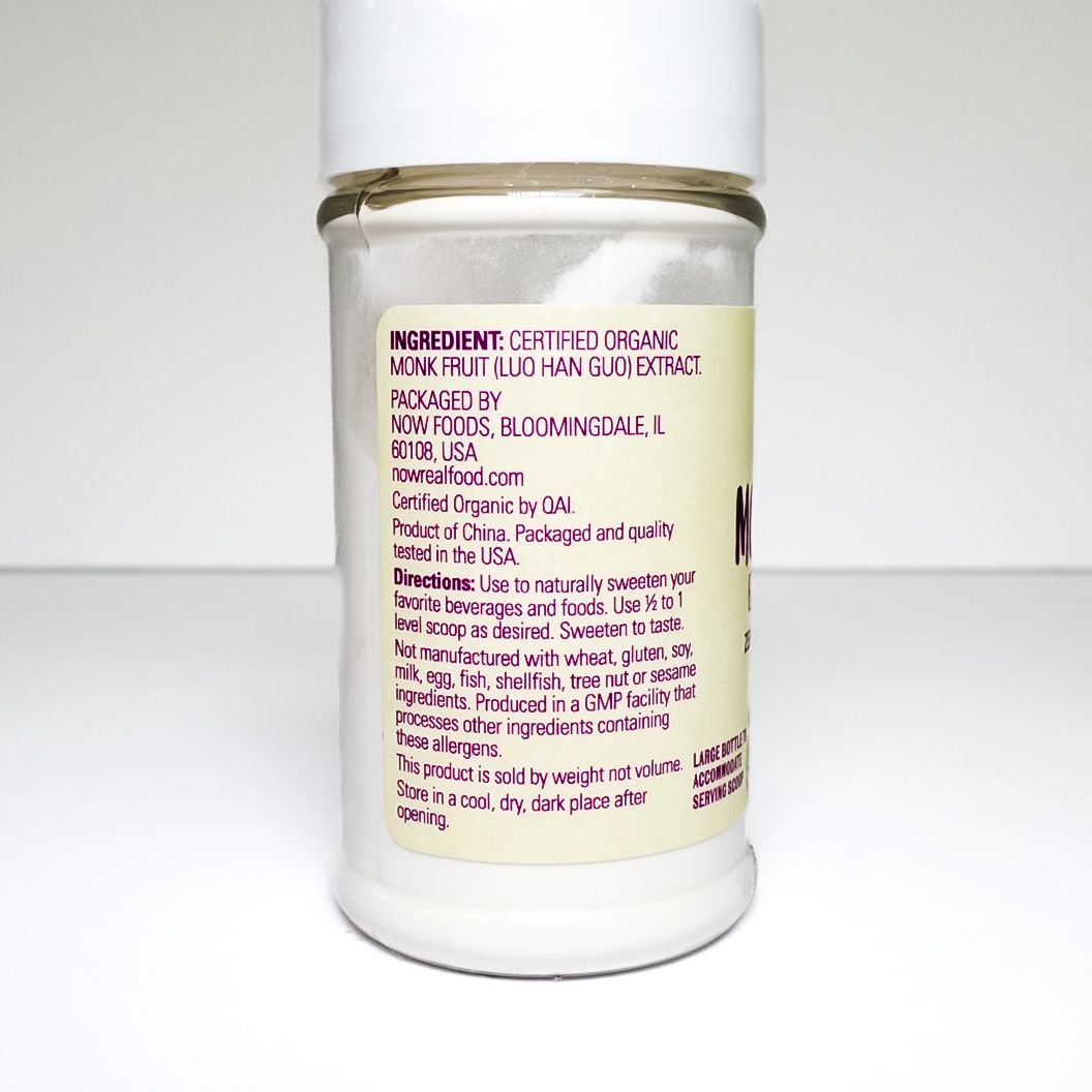 White jar of organic monk fruit extract powder on a light background