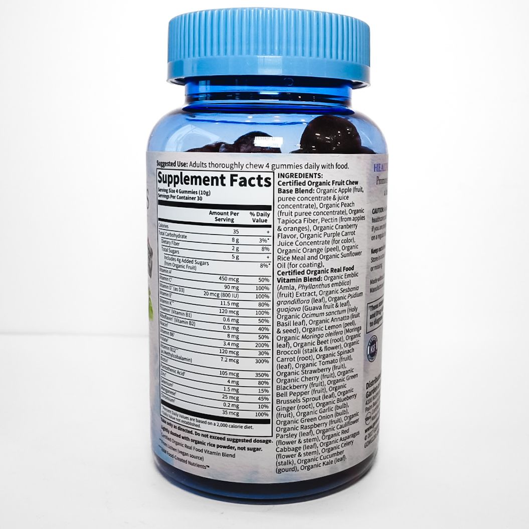 Blue bottle of Organics Men’s Multi vitamins with colorful fruit label on white background