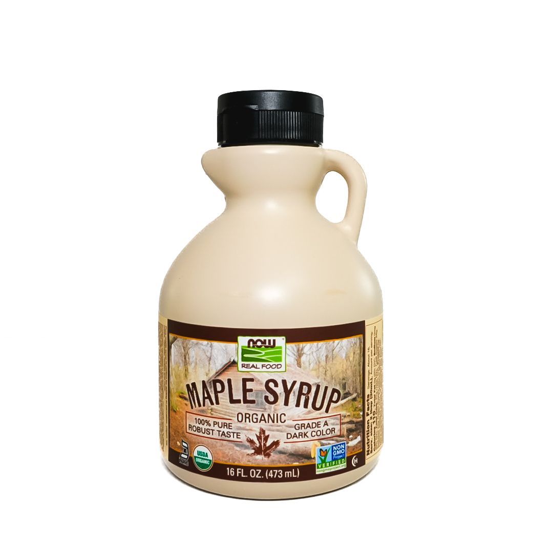 Bottle of maple syrup with a black cap and cream-colored jug, label reading “Maple Syrup.”