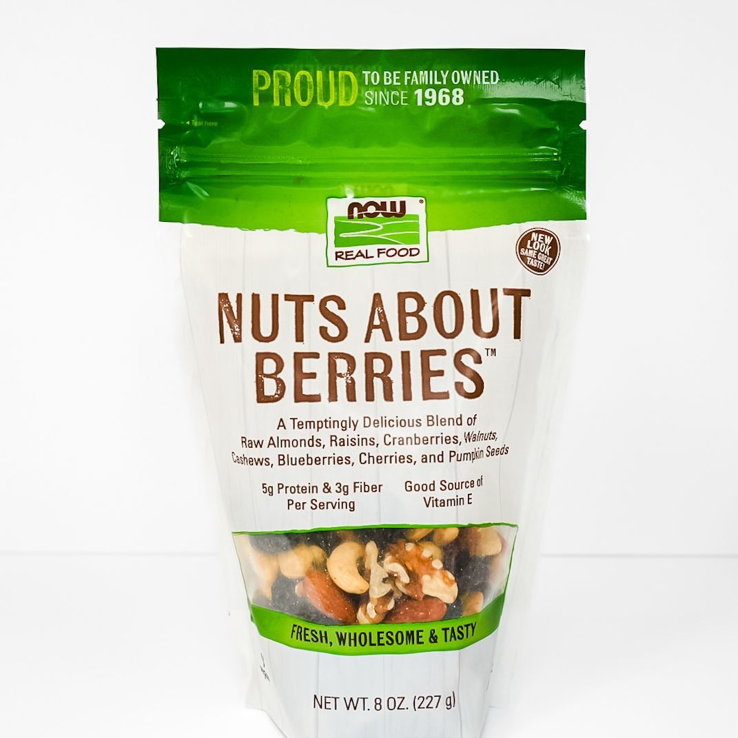 White and green pouch of Nuts About Berries snack mix with mixed nuts and dried fruit shown on front