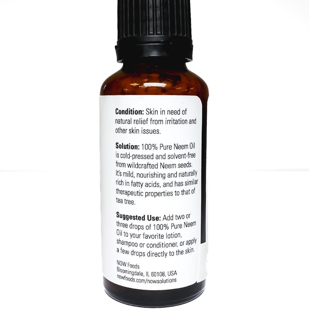Neem oil dropper bottle with black cap and green leaf label on white background