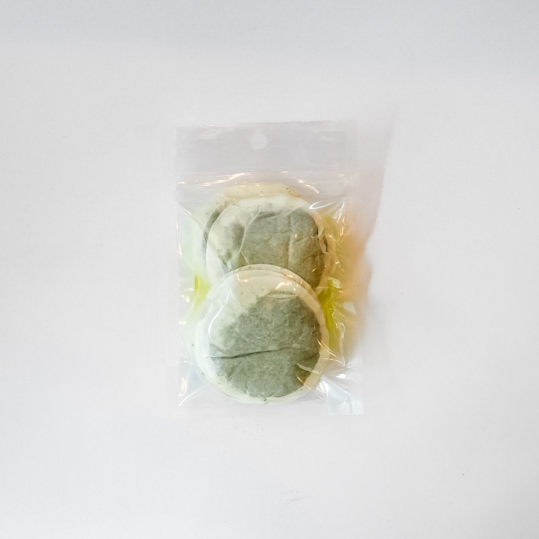 Plastic bag of nettle leaf tea bags with a bright yellow label on a white background