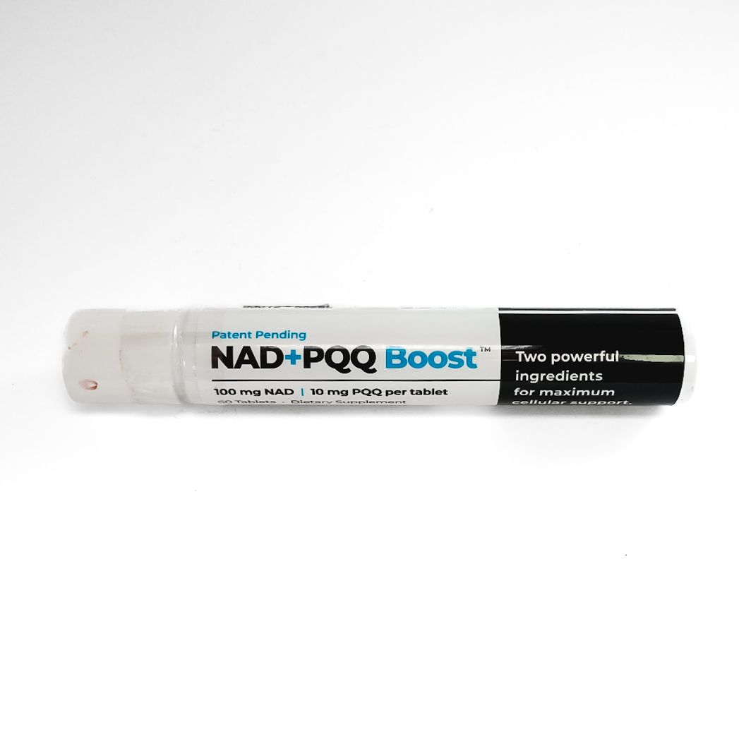 NAD+ Poo Boost lip balm tube, white and black packaging, lying horizontally on a white background