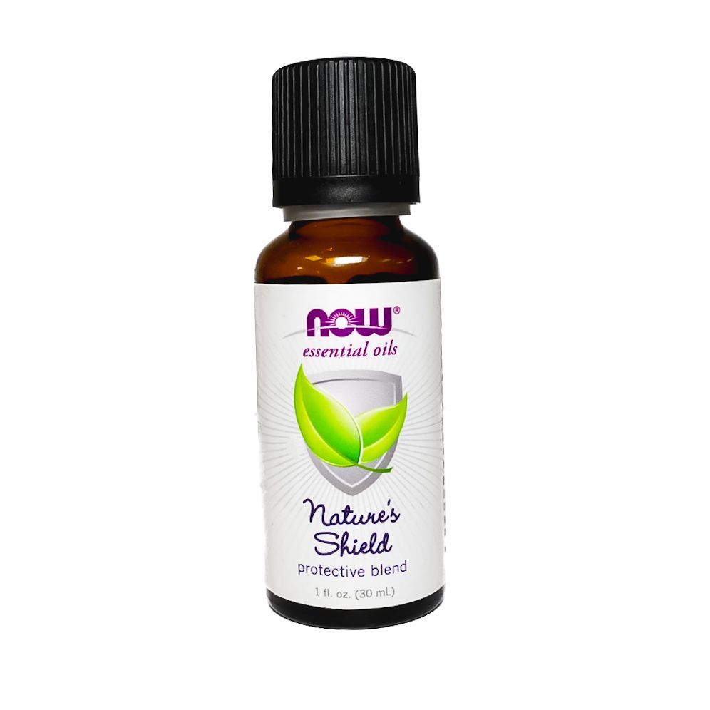 Small amber essential oil bottle with black cap and green leaf label on a white background