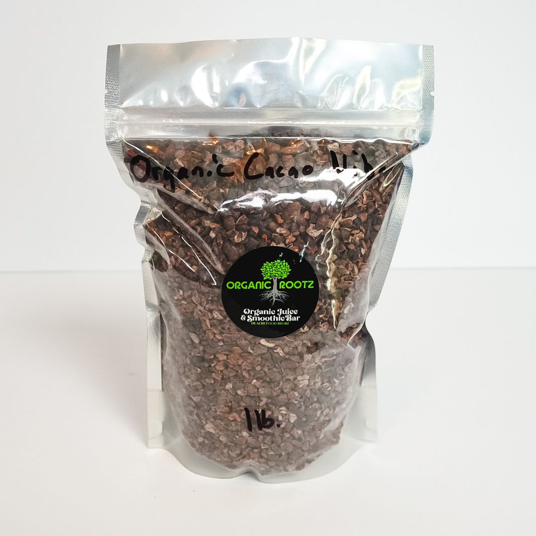 Clear plastic bag of organic roasted coffee beans with a black label and handwritten text on top.