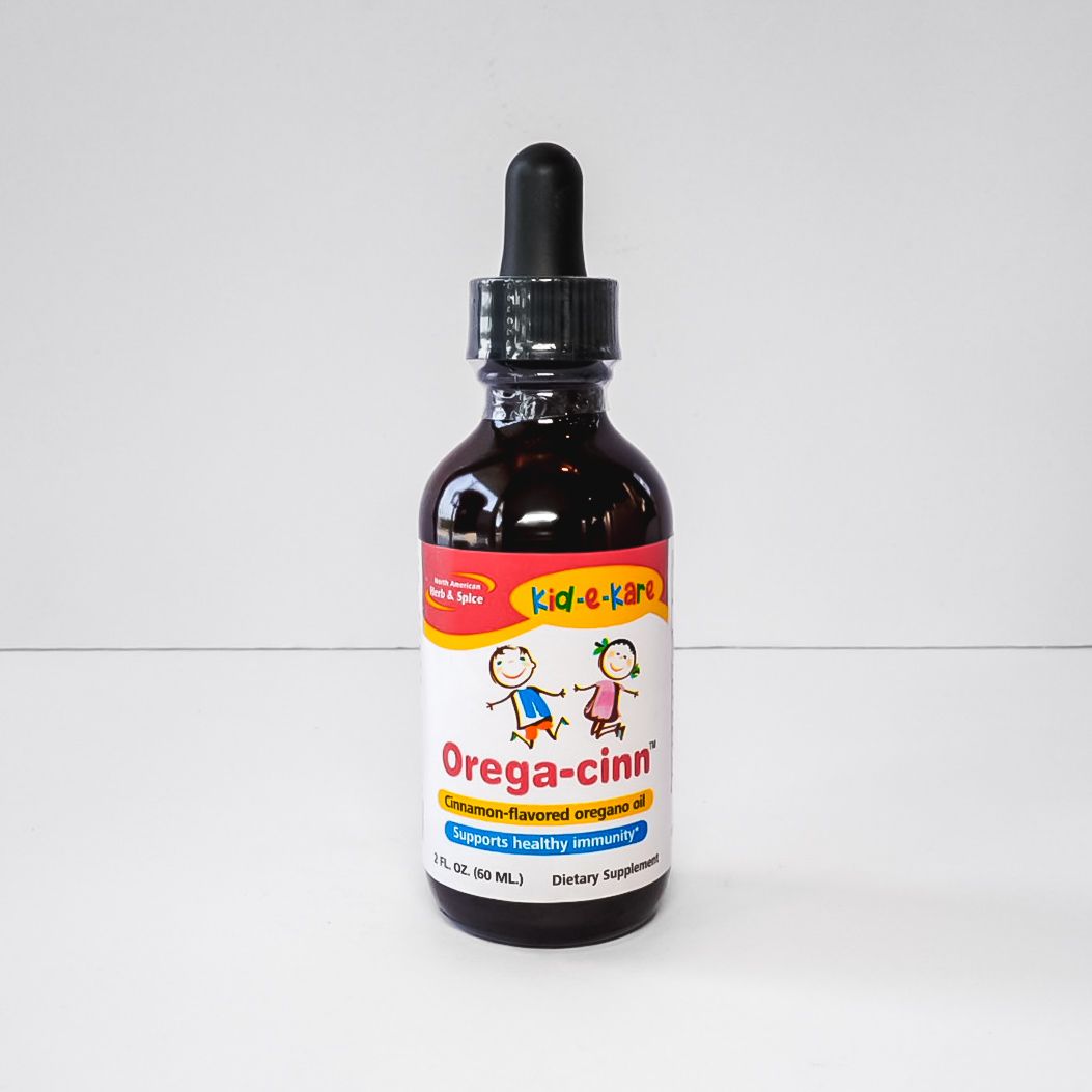Dark amber dropper bottle labeled “Orega-cin” on a white background