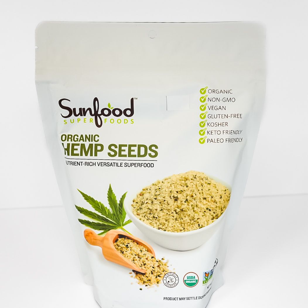 Sunfood Organic Hemp Seeds pouch with bowl of seeds and hemp leaves on white background