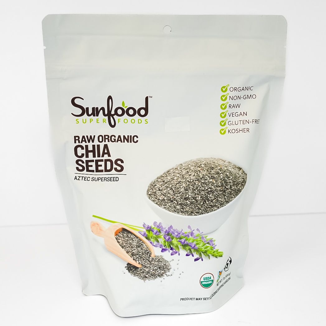White pouch of Sunfood raw organic chia seeds with seed image and purple flower illustration
