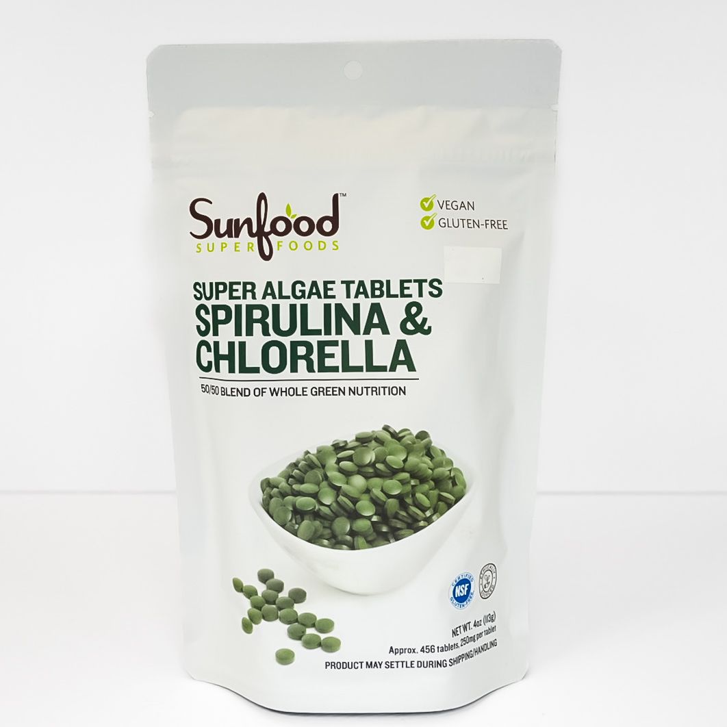 Sunfood Super Algae Tablets Spirulina & Chlorella pouch with green tablet bowl on white background