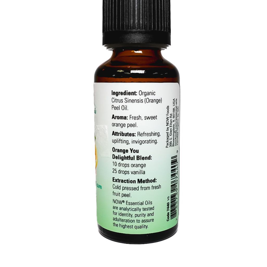Bottle of NOW orange essential oil with orange slice label on white background