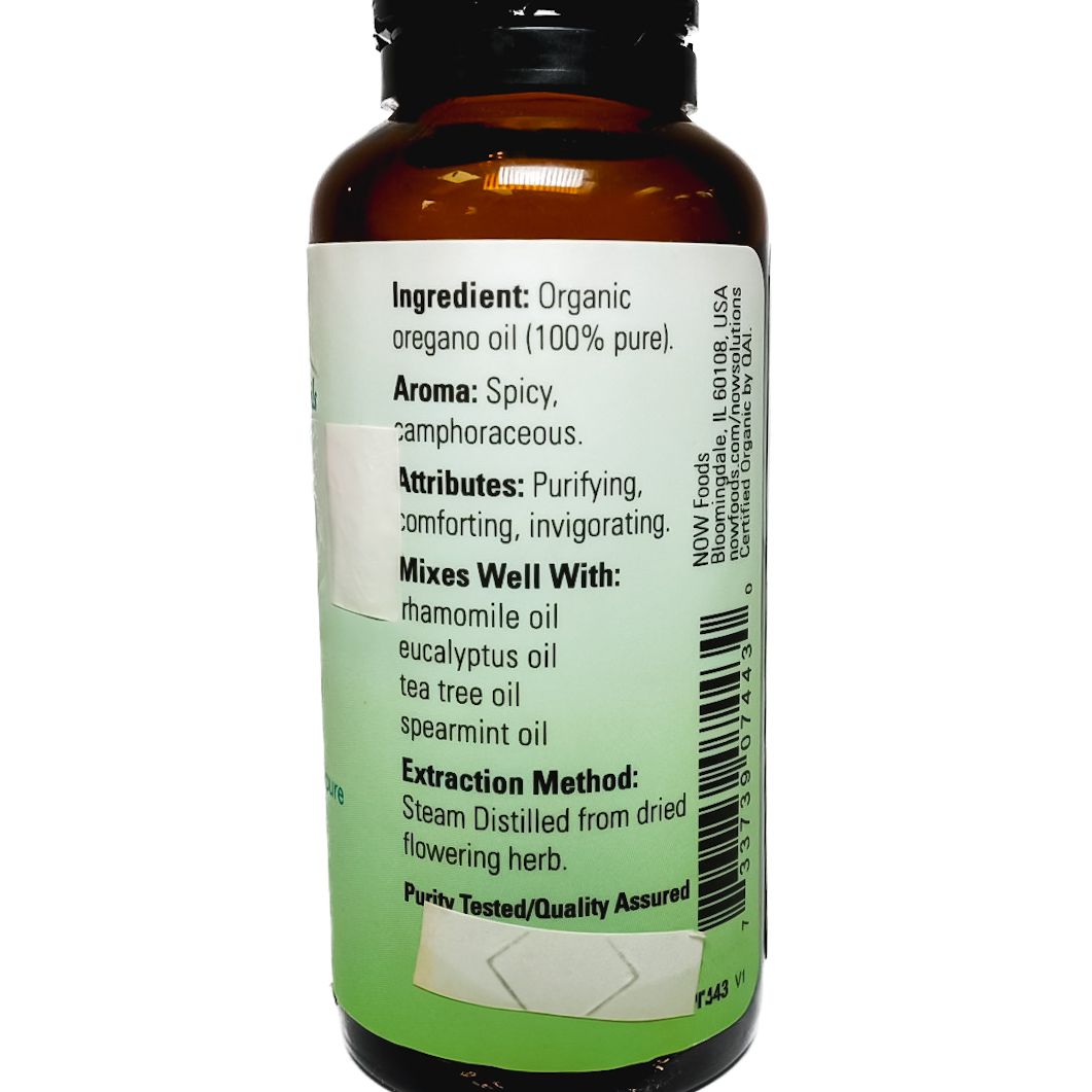 Bottle of NOW oregano essential oil with green label and black cap