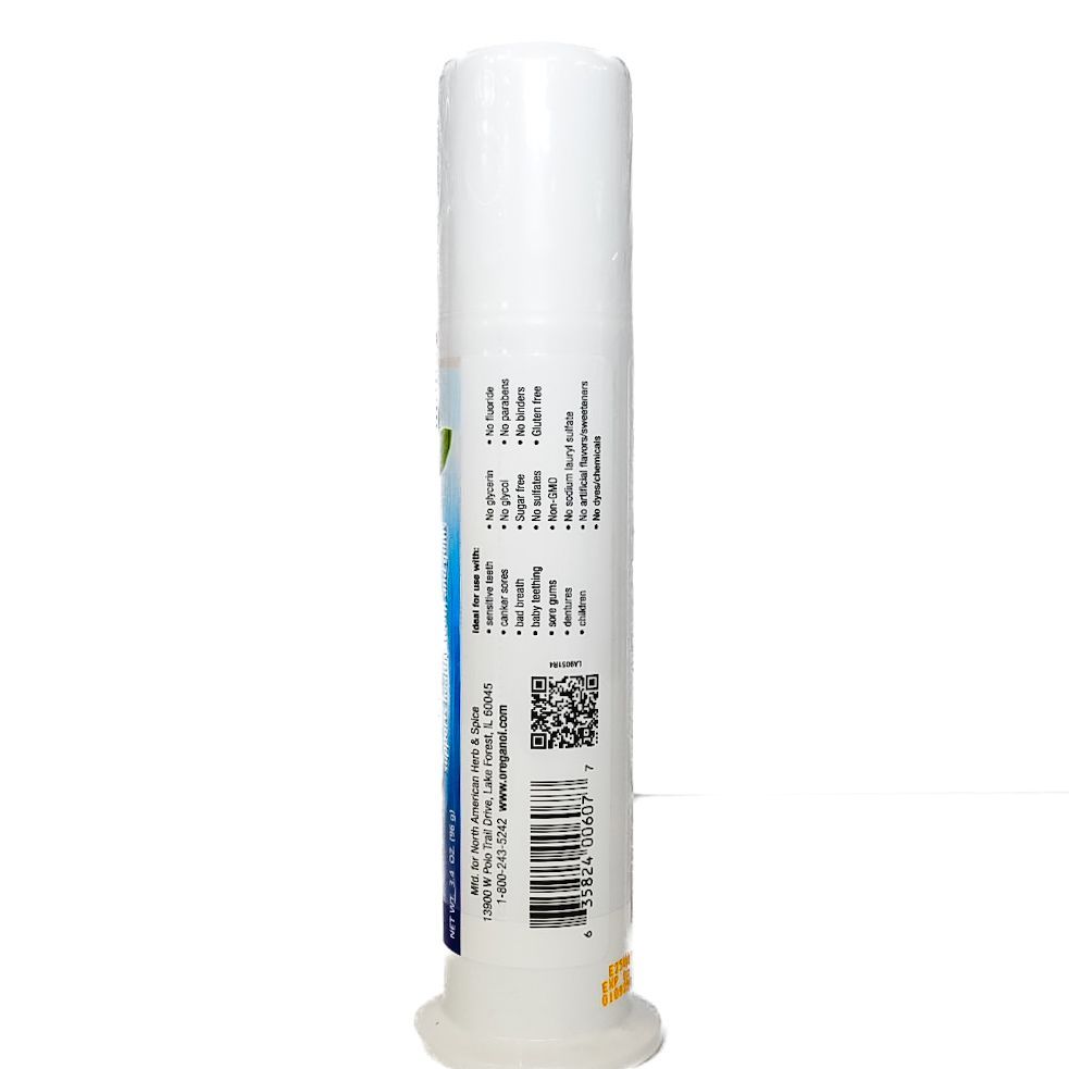 White-capped blue-and-green Oral-B toothpaste tube standing upright on a white surface.