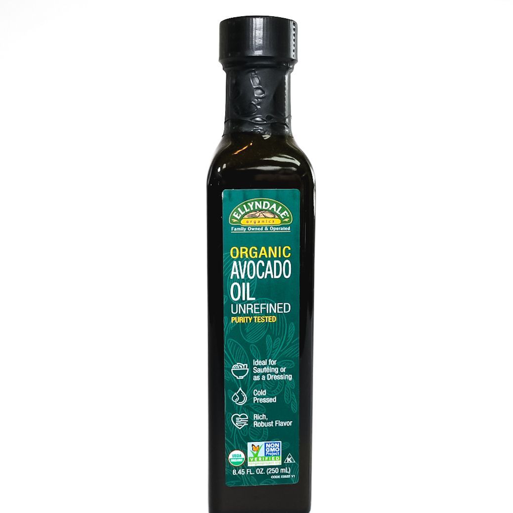 Bottle of organic avocado oil with green label and black cap on a white background