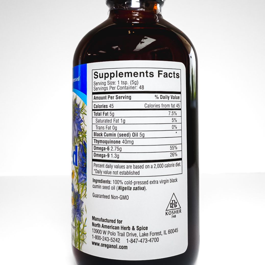 Brown bottle labeled “Black Seed” with a blue and white label on a white background