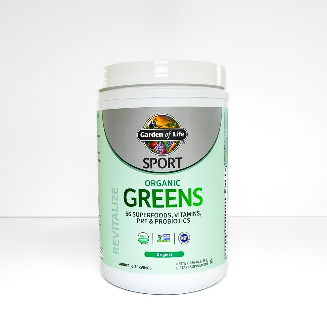 White jar of Garden of Life Sport Organic Greens supplement on a white background