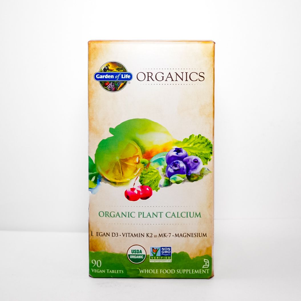 Orange Organics Organic Plant Calcium supplement box with fruit and leafy graphics on a white background