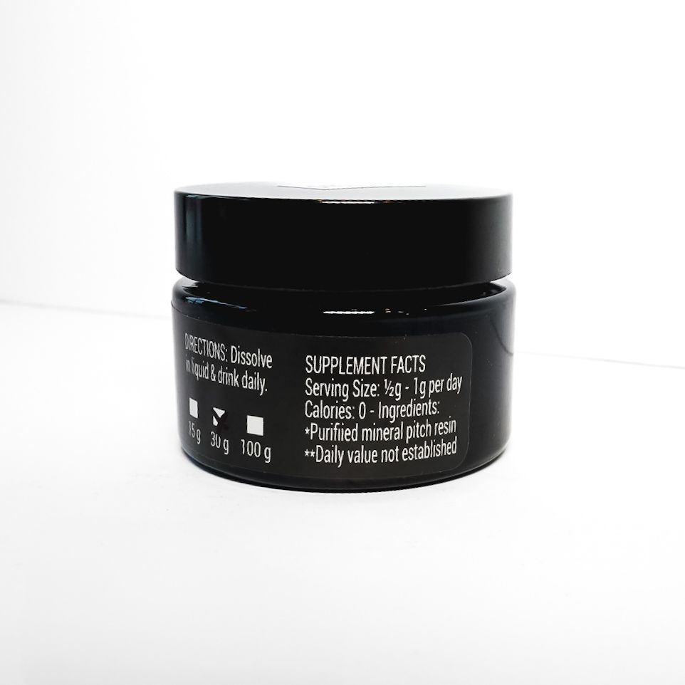 Black Organic Rootz Shilajit supplement jar with green and white label on a white background