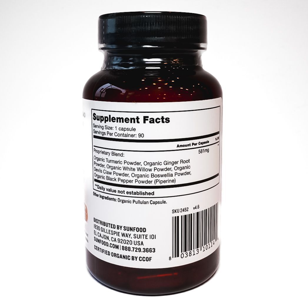 Bottle of Sundhed Organic Turmeric & Super Herbs supplement on white background