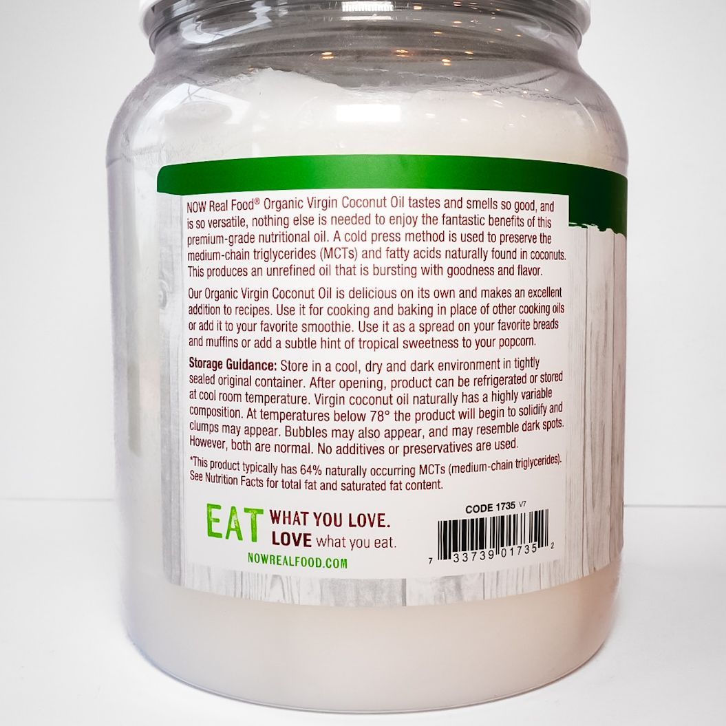 Jar of NOW Foods organic virgin coconut oil with green label on white background