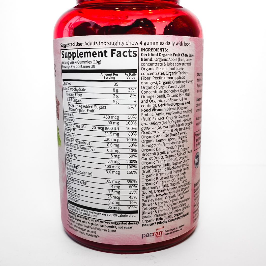 Bottle of Organics Women’s Multi vitamins with a pink label and white cap