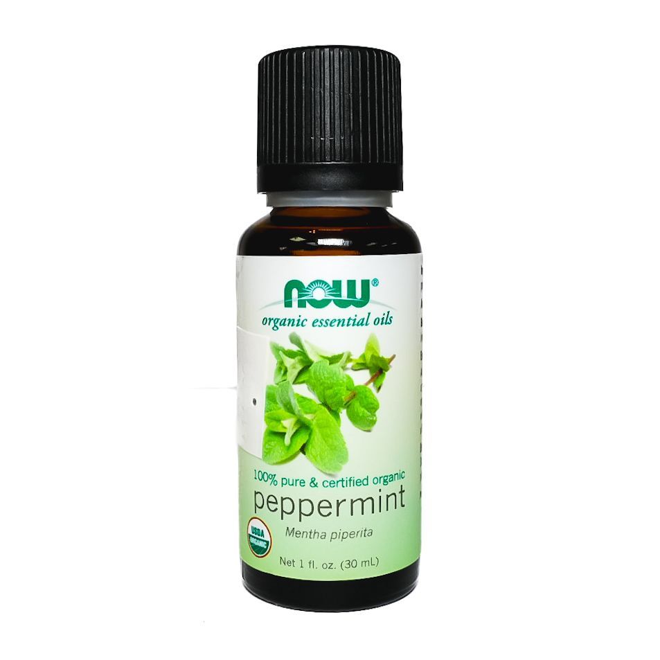 NOW Peppermint essential oil bottle with green peppermint leaves on a white background