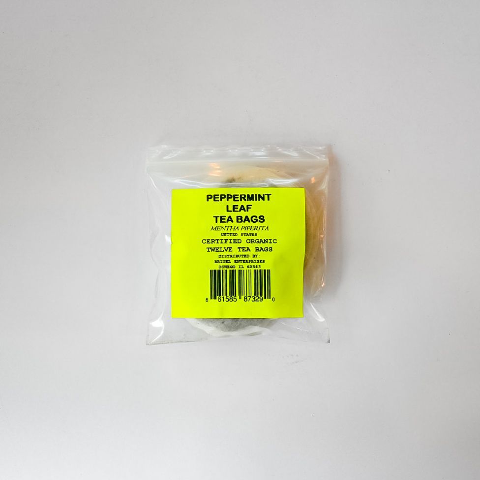 Clear plastic bag of peppermint leaf tea bags with a bright yellow label on a white background