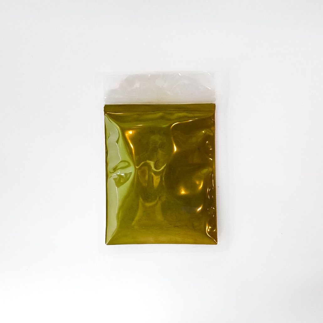 Small clear plastic bag with yellow-green contents and a bright yellow label on a white background