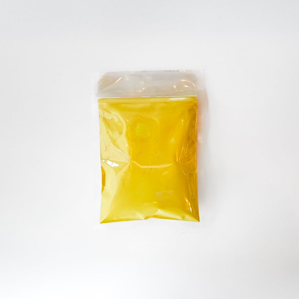 Yellow packaged pine pollen in a clear plastic bag with a bright label