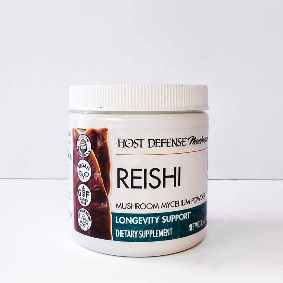 White jar of Host Defense Reishi mushroom dietary supplement with teal and beige label.