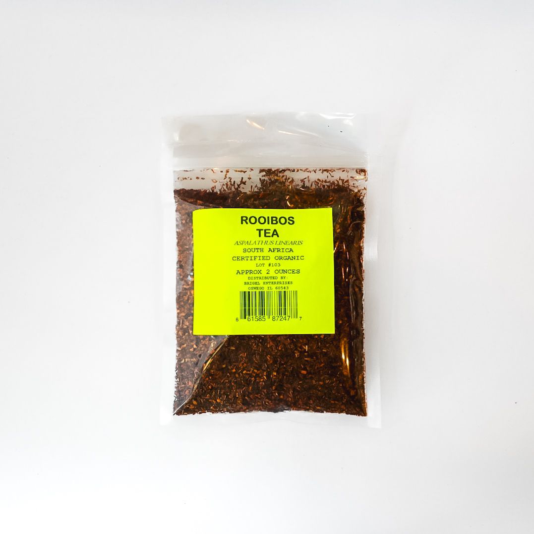 A clear plastic bag of rooibos tea with a bright yellow label on a white background.