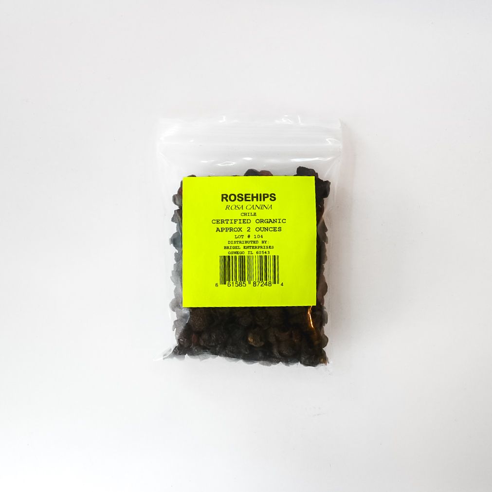 Clear plastic bag of dried rosehips with a bright yellow label on a white background