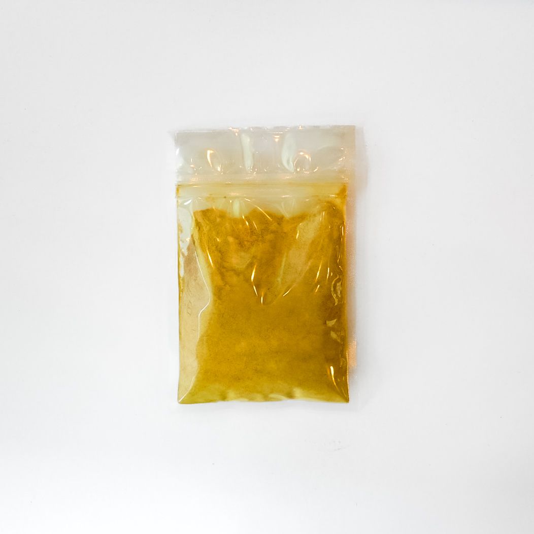 Red maca powder packet with yellow label on a white background