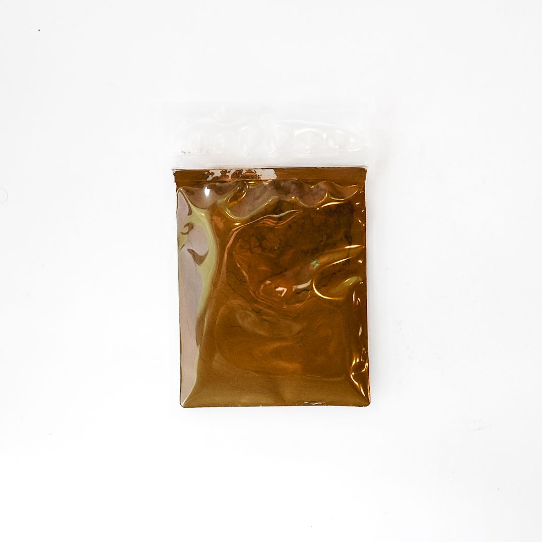Clear plastic bag of mushroom powder with a bright yellow label on a white background