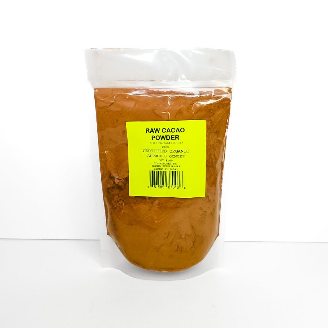 Clear bag of orange-brown powder with a neon yellow label, standing upright on a white surface.