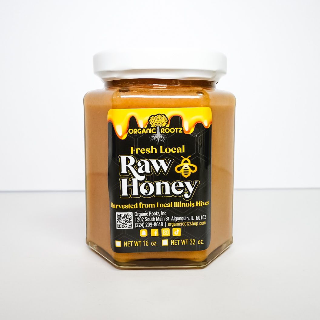 Jar of Irish local raw honey with a white lid and black label on a white background