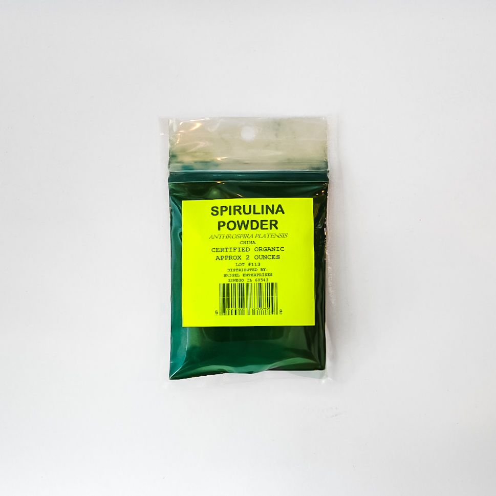 Spirulina powder packet with bright yellow label on a white background
