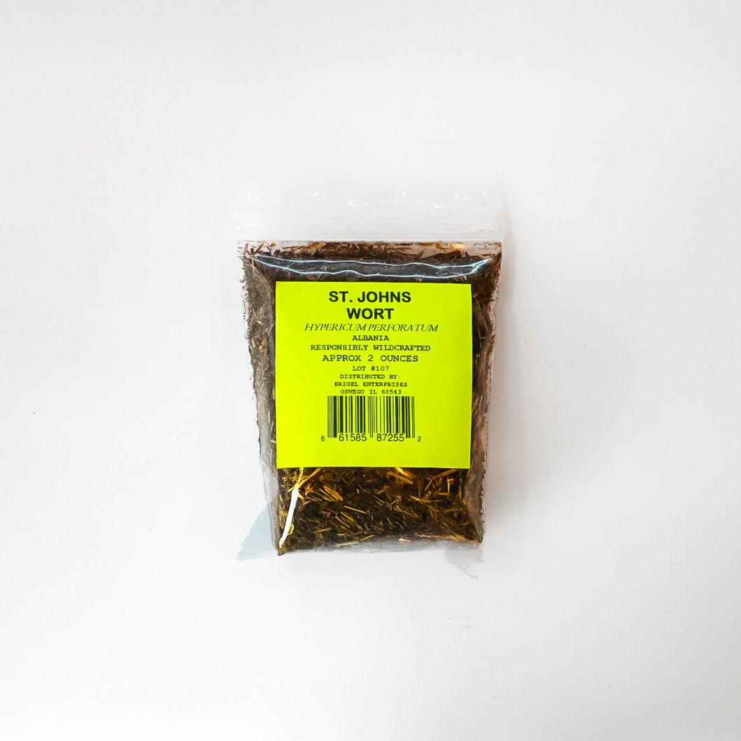Small clear bag of brown dried herbs with a bright yellow label on a white background