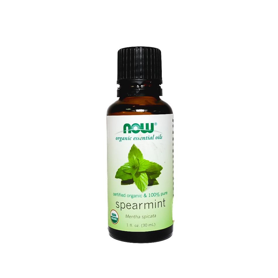 NOW peppermint essential oil bottle with green label and black cap on a white background
