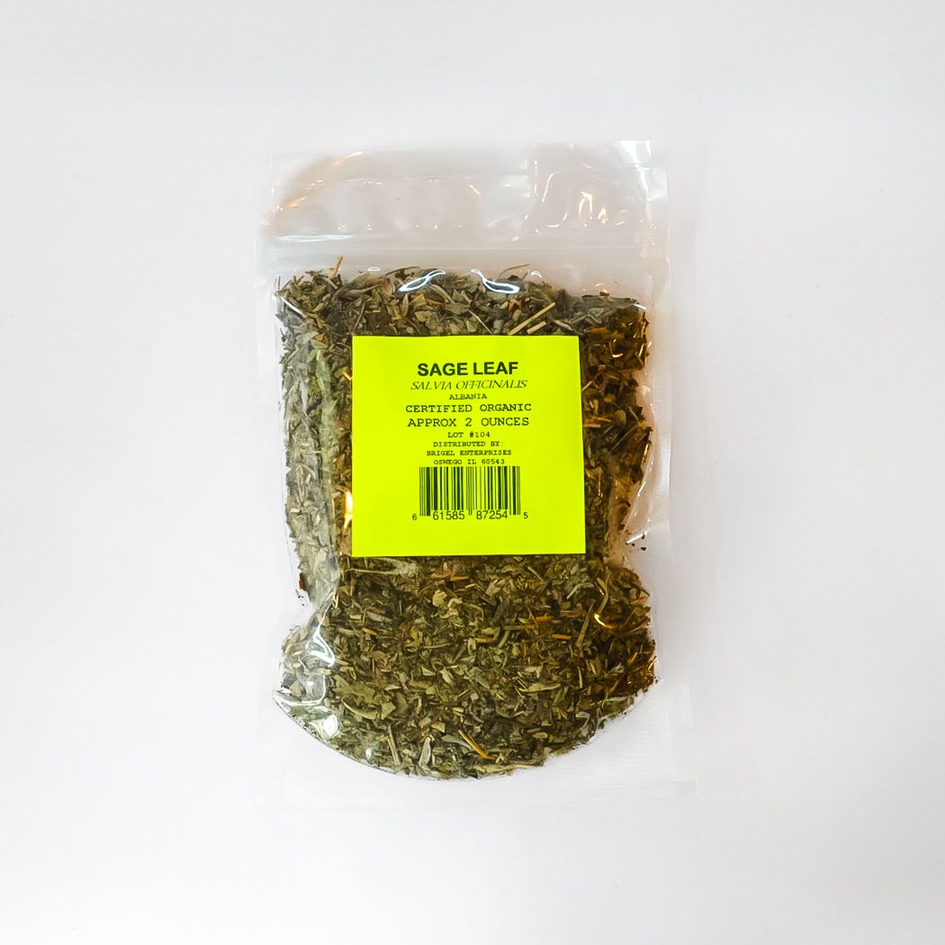 Clear plastic bag of dried herbs or tea with a bright yellow label on a white background