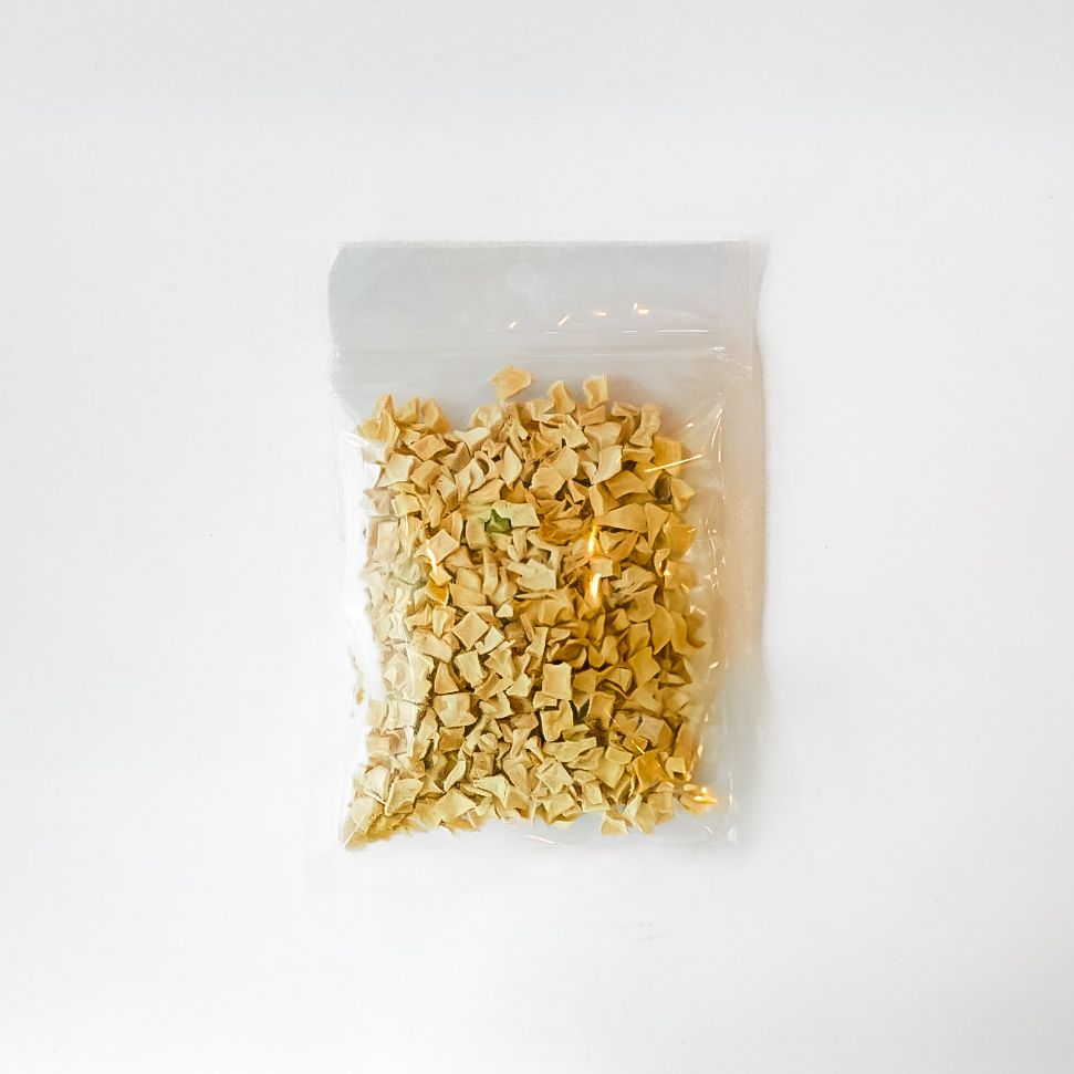 Clear bag of dried soursop fruit with a bright yellow label on a white background