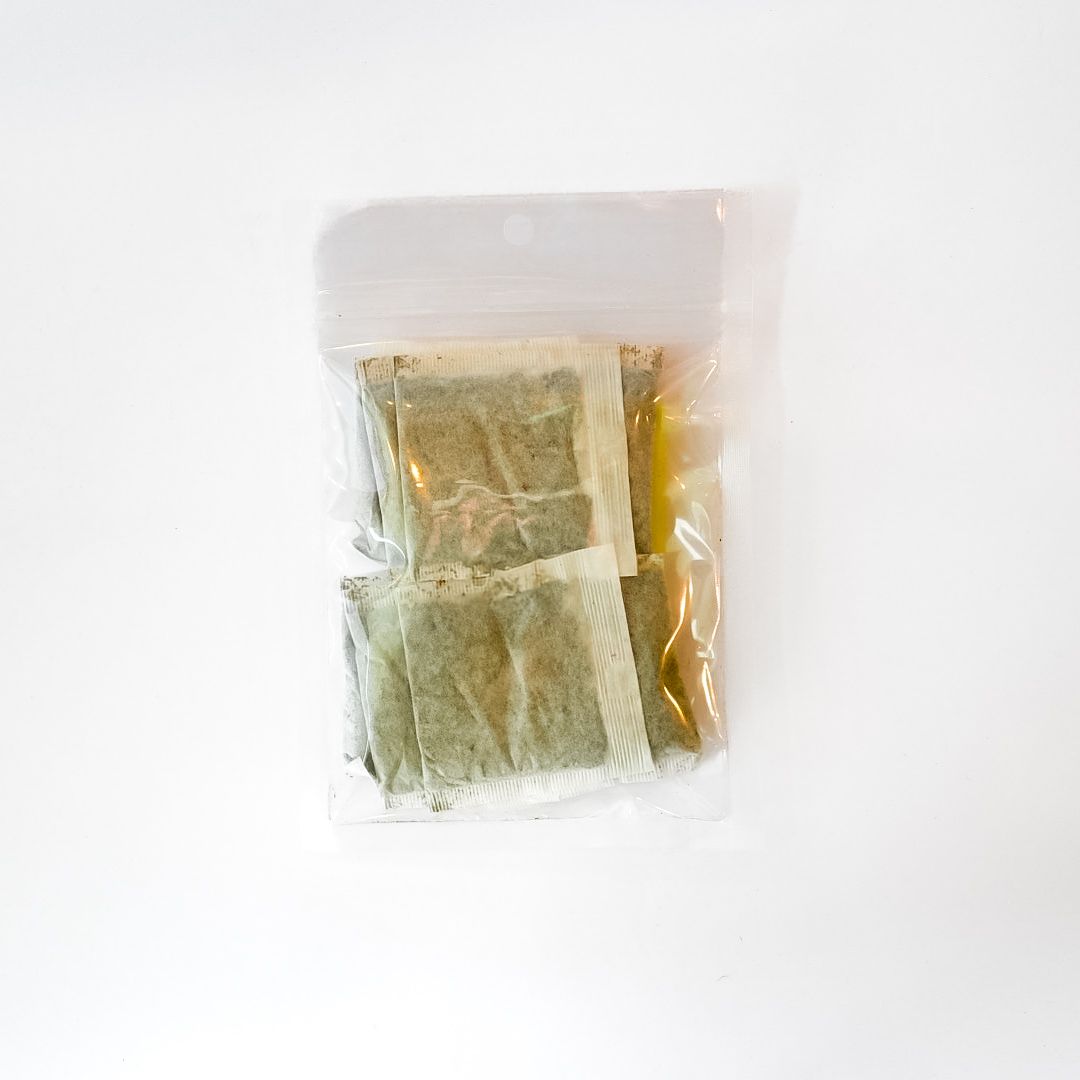 Clear plastic bag of yellow-spearmint leaf tea bags with a bright yellow label
