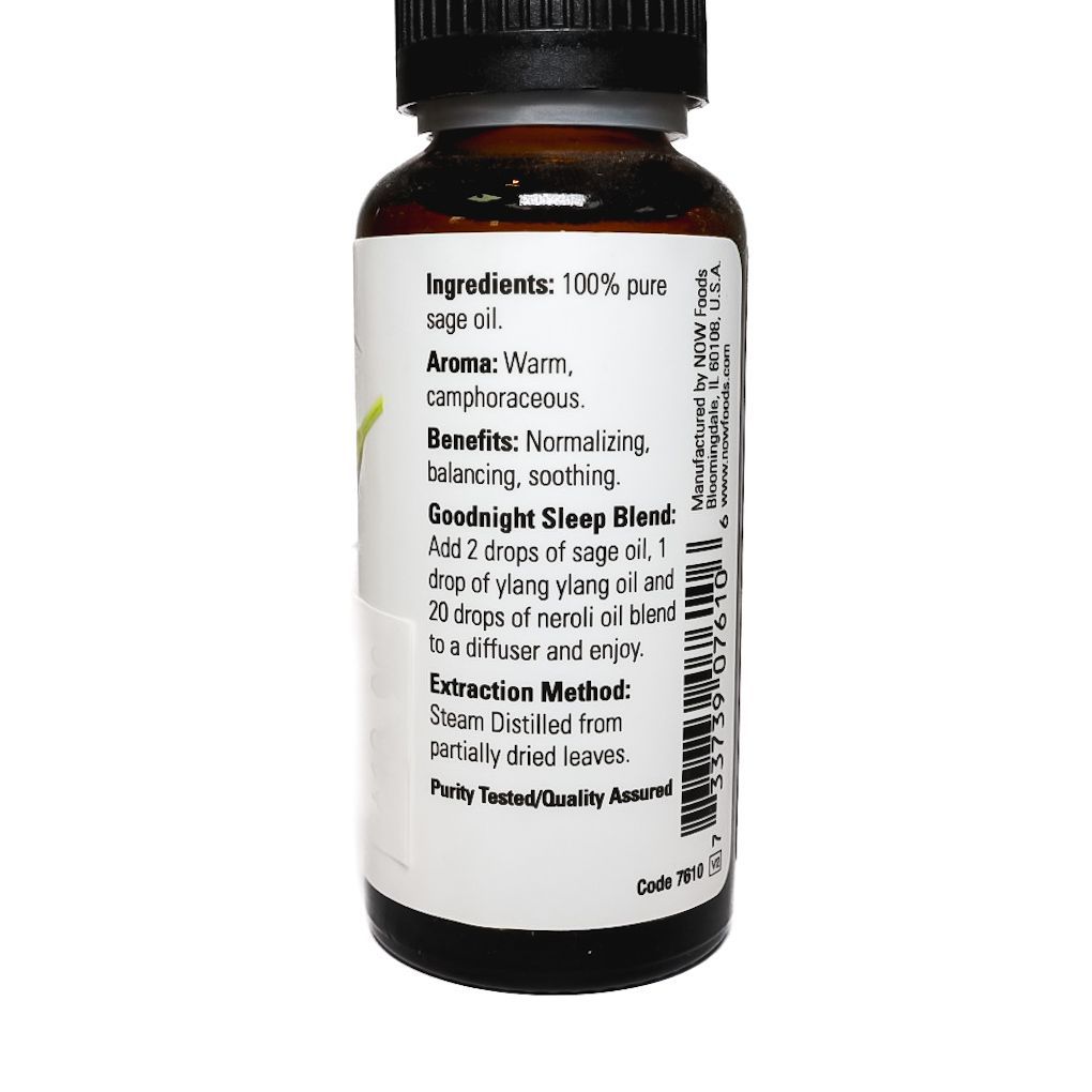 Small bottle of NOW essential oil labeled “Sage” with a black cap on a white background