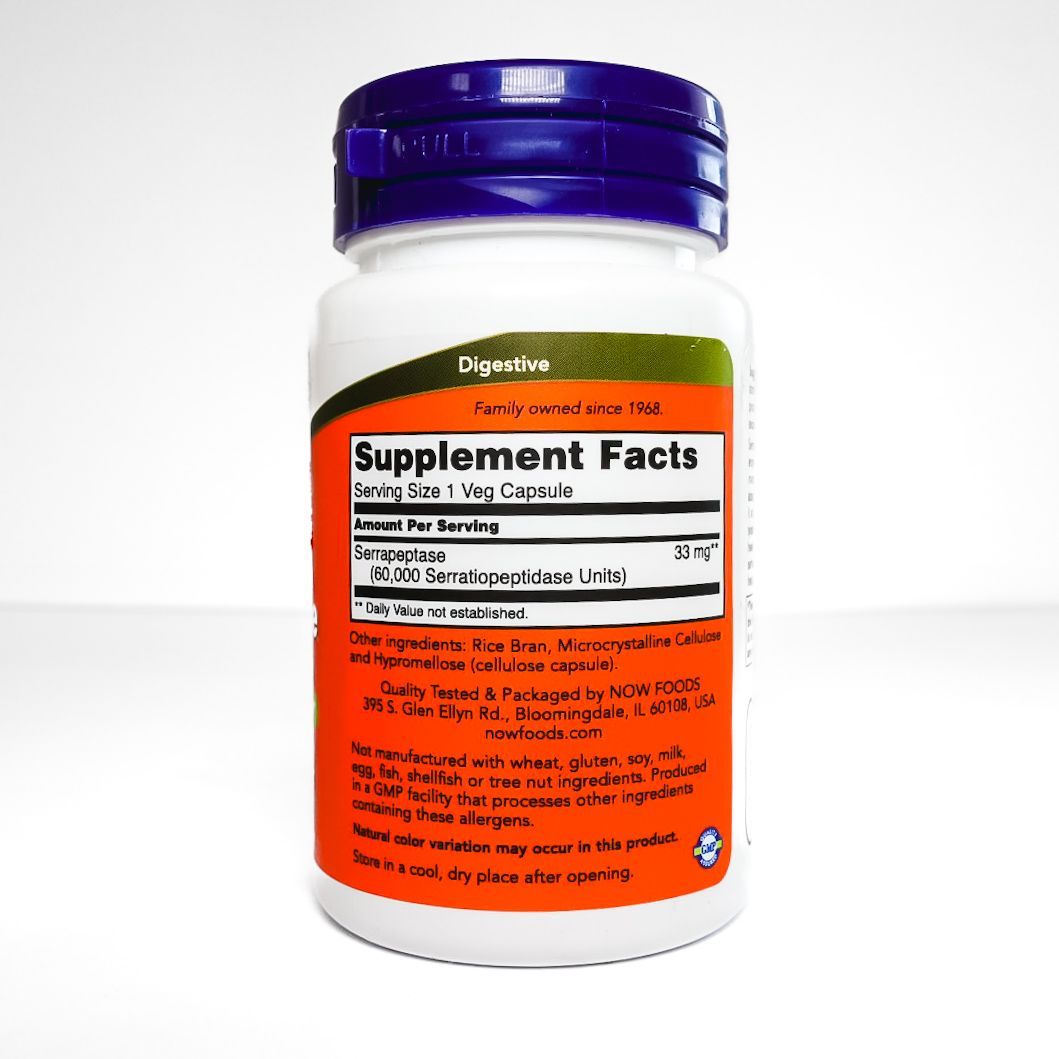 NOW Serrapeptase supplement bottle with purple cap and orange label on white background