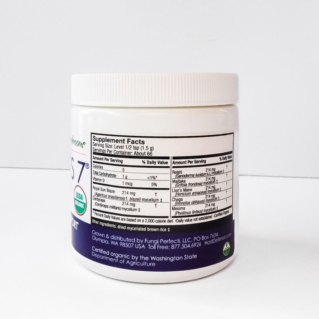 White jar of Host Defense Stamets 7 mushroom mycelium powder with purple label on a white surface