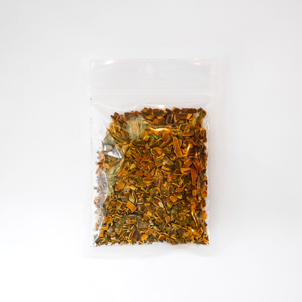 Small clear plastic bag of dried herbs with a bright yellow label and barcode on a white background