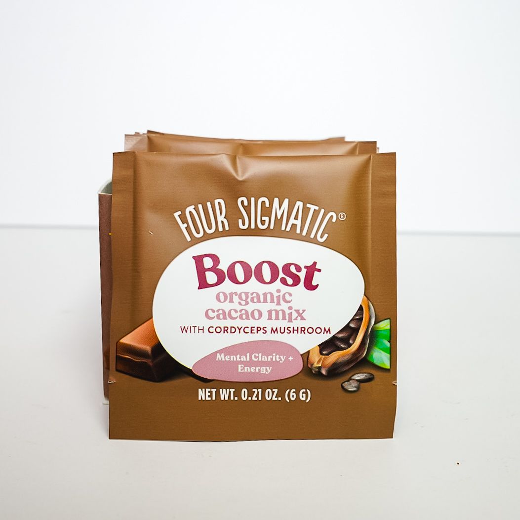 Four Sigmatic Boost organic cacao mix in brown pouch on white background