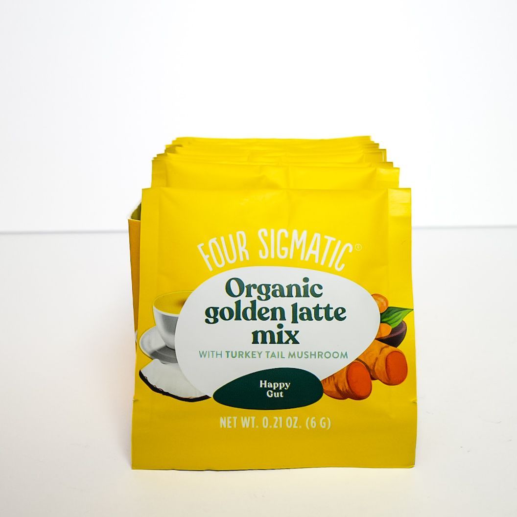 Yellow Four Sigmatic Organic golden latte mix package on a white background