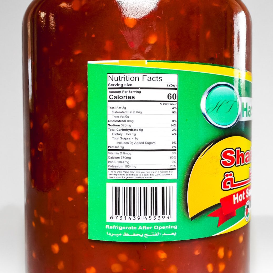 Habash hot sauce jar with red lid and green label on a white background